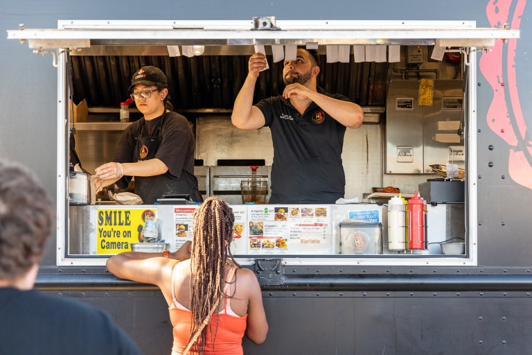 woman standing at food truck