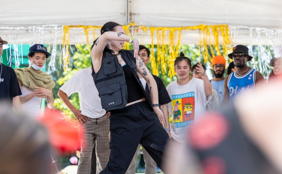 woman dancing on stage in front of crowd on Community Stage
