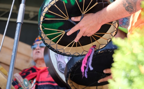 person holding Indigenous drum at Surrey Canada Day